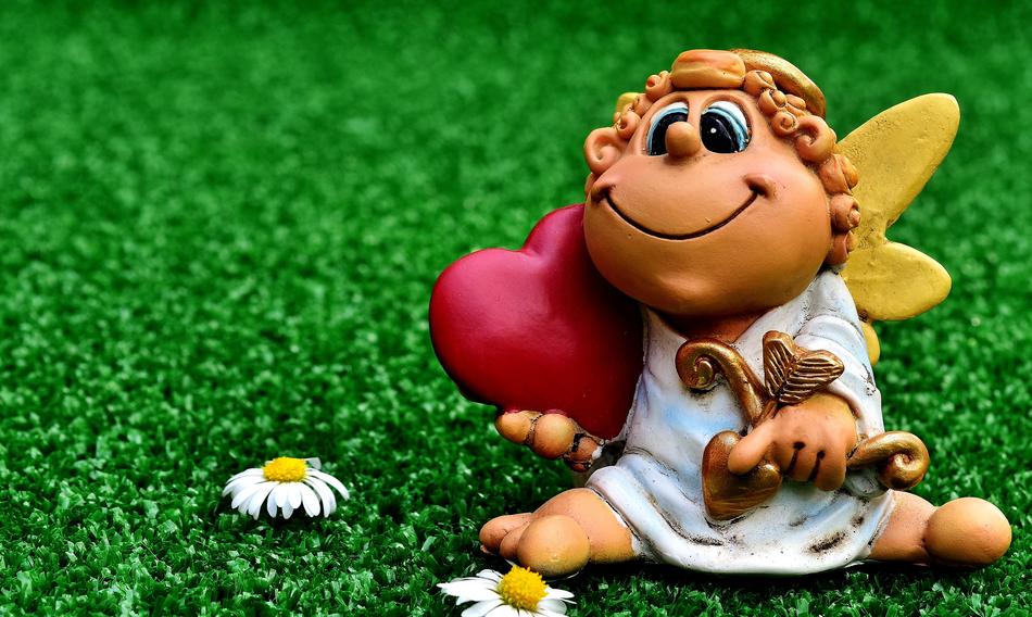 figurine of the guardian angel on a green meadow