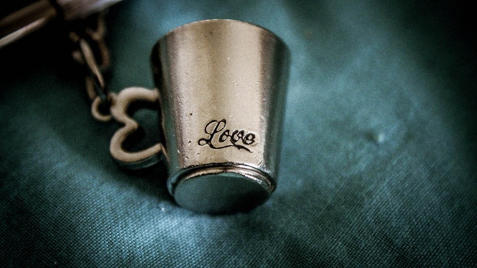 mug on a chain with the inscription love