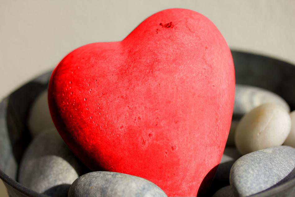 Close-up of the beautiful, red and pink stone heart among the other colorful stone