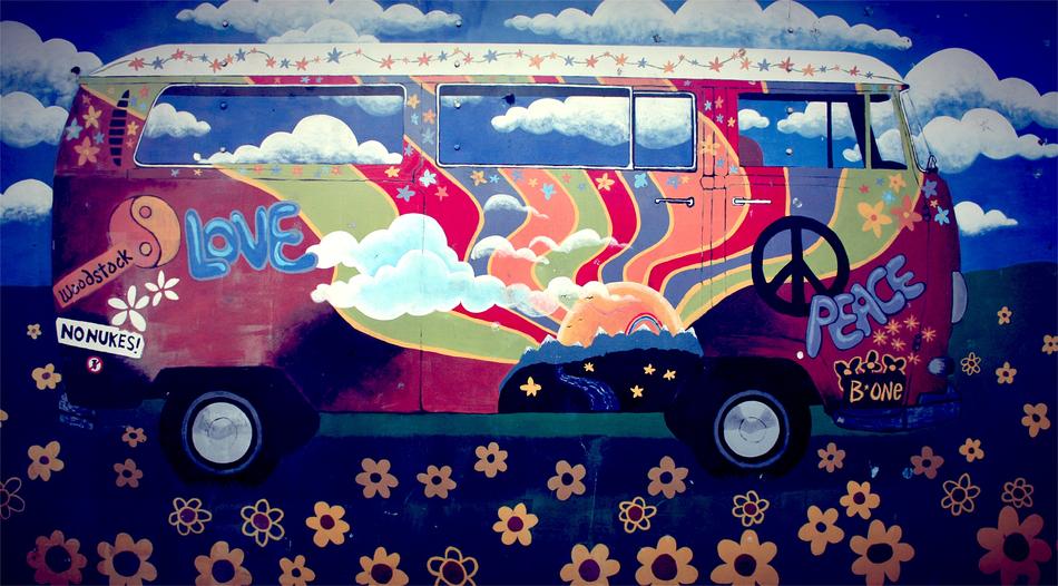 Graffiti of the colorful and beautiful Hippie Van, among the flowers, under the blue sky with clouds, in Amsterdam, Netherlands