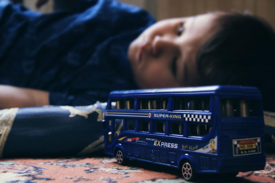 Sad Child and Double-Decker Toys
