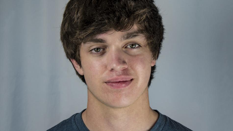 Portrait of the guy in t-shirt, at blurred background