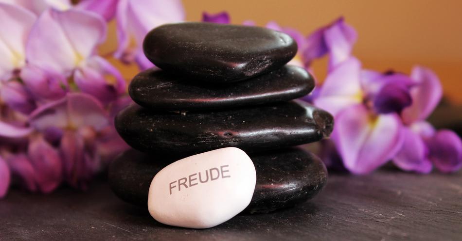 stones for meditation on blurred floral background