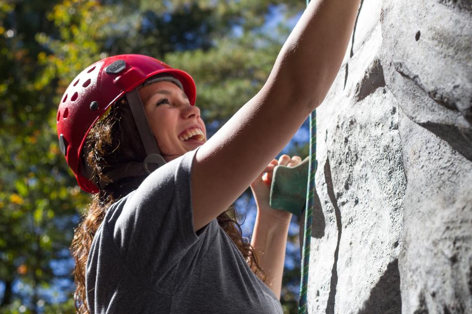 girl in a red helmet on a rock