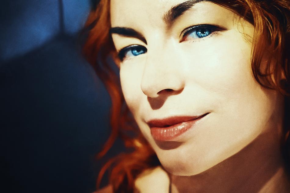 Portrait of the girl with make-up and blue eyes, in light