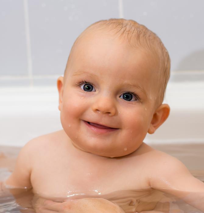 little child in the water in the bathroom