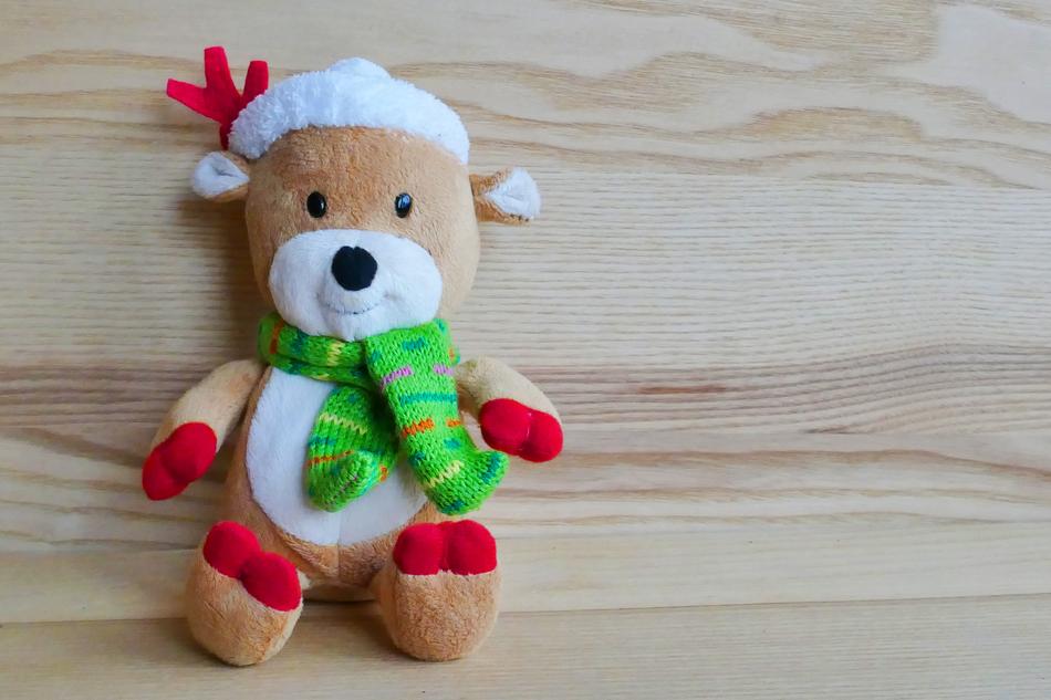 Cute, colorful and beautiful Reindeer toy with clothing, on the wooden surface