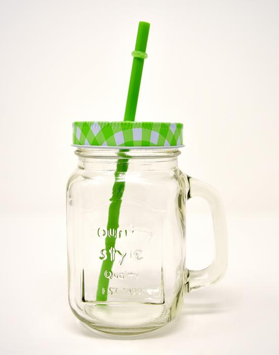 transparent jar with green lid and straw