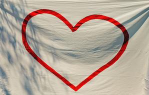 red heart on white cloth