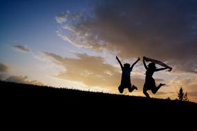 Girls Jumping Sunset