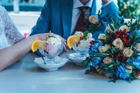 newlyweds, dessert and bouquet on the table