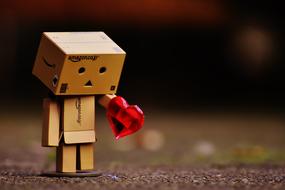 Cute Danbo figure with the beautiful, red heart, on the ground