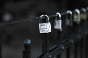 a row of romantic locks on a lattice