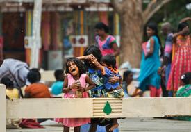 Smiling children in colorful clothing, outdoors