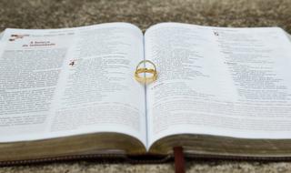 gold wedding rings lie on open bible