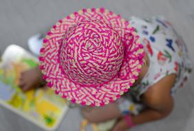 Little Girl Playing with pink hat