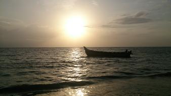 lonely boat, romantic sunset over the ocean