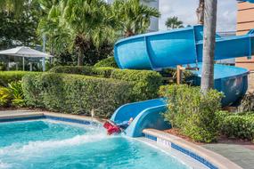 Child on Water Slide in swimming Pool