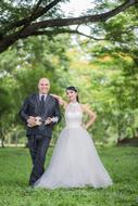 happy bride and groom in green park