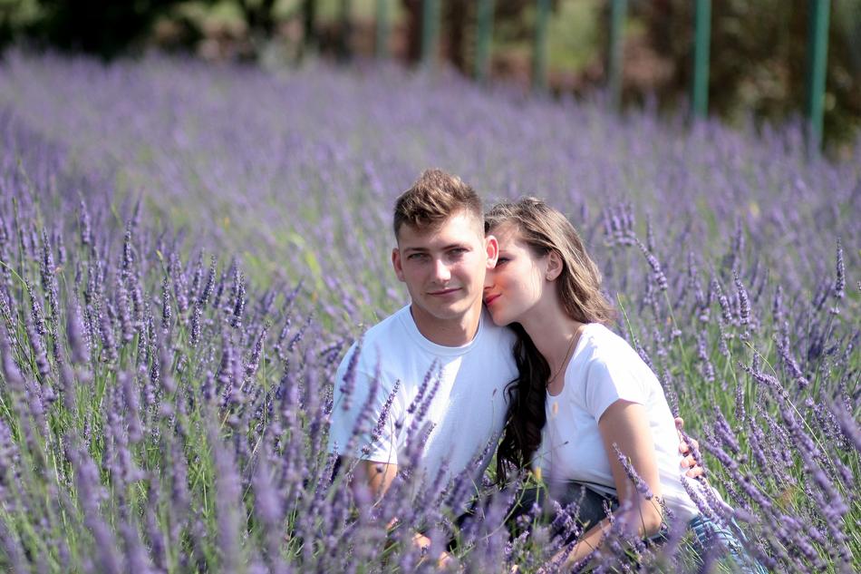 Couple posing among the beautiful field of lavender flowers