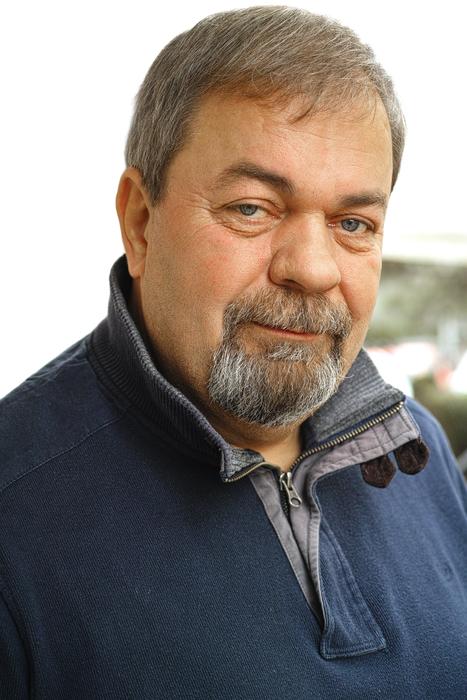 Portrait of the grandfather with beard, wearing blue shirt
