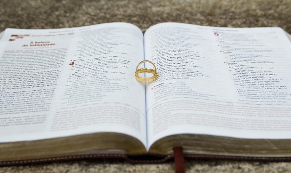 gold wedding rings lie on open bible