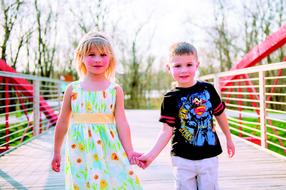 children holding each other hands on the playground