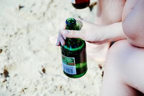 a bottle of beer at a girl