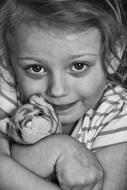 girl hugging a tiger toy