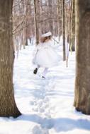 Little Girl Running in Snowy wintry forest