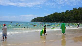 people vacationing on the beach by the sea