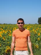 man in a field of sunflowers