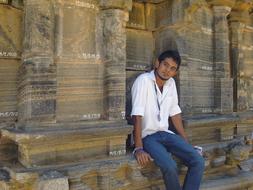 The guy sits on the ancient ruins