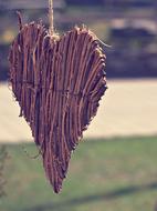 wooden heart hanging in front of the house