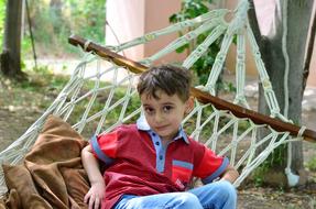 Boy lies in a hammock