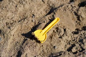 yellow rake with sand