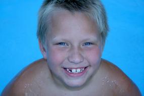 portrait of happy boy in swimming pool