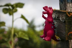 Toy red dragon on the fence