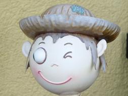 Winking boy figurine