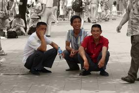 Three men are resting in the shade