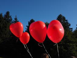 Four red balloons in the sky