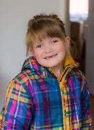 Little girl in colorful jacket smiling