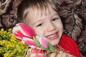 happy child with a bouquet of flowers