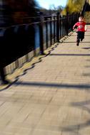 Joyful little boy running across the bridge