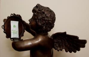 Bronze angel holding matcha tea