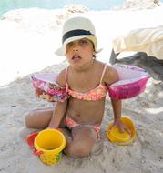 a child is playing on the beach