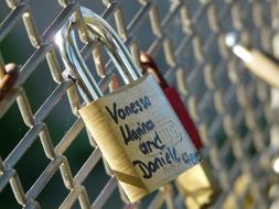 an iron lock on the fence with the inscription