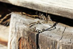 a wooden stump with an iron wire