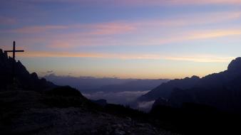 cross silhouette mountains sky blue