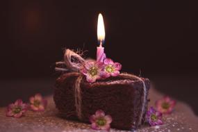 Brownie Cake with candle at top in darkness, Greeting Card